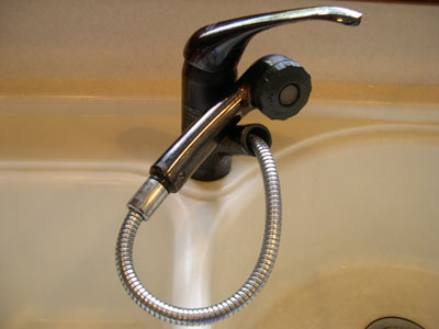 a pull-out kitchen faucet is perfect to supply warm water to a 	portable shower